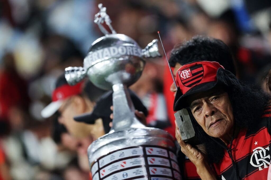 Torcida do Flamengo promete provocar Palmeiras com mosaico no Maracanã; veja detalhes Torcida do Flamengo em jogo no Maracanã. com foco em um torcedor caracterizado segurando réplica da taça da libertares da américa